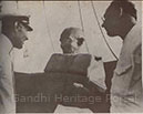 Gandhi receiving instructions on lifeboat practice from Capt. Marton Jack